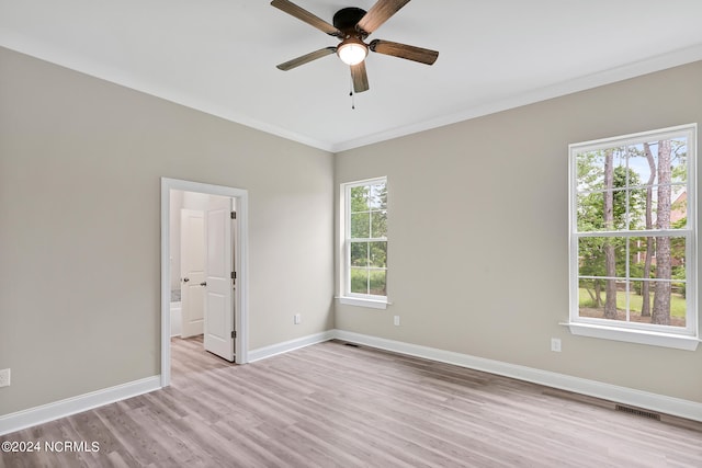 spare room with crown molding, light hardwood / wood-style floors, a healthy amount of sunlight, and ceiling fan