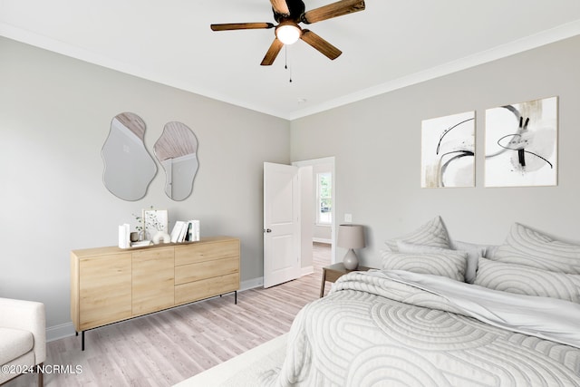 bedroom with light hardwood / wood-style flooring, crown molding, and ceiling fan