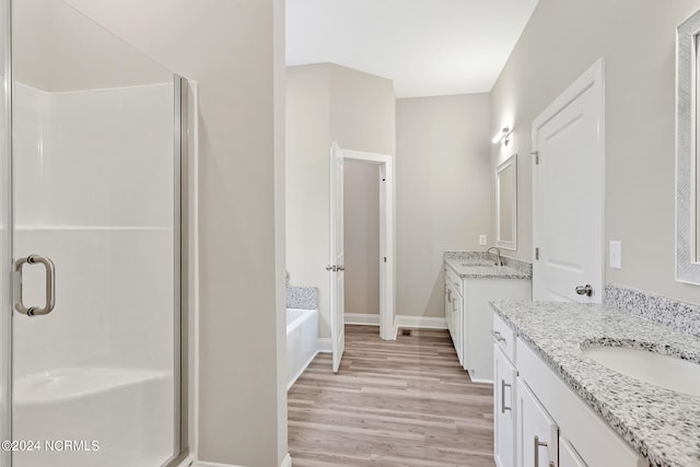 bathroom featuring vanity, independent shower and bath, and hardwood / wood-style floors