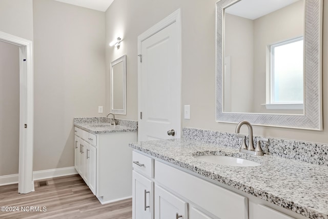 bathroom with vanity and hardwood / wood-style flooring