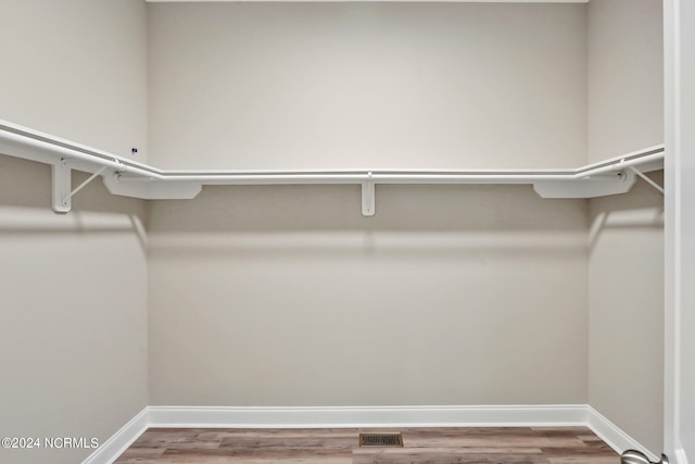 walk in closet featuring hardwood / wood-style floors