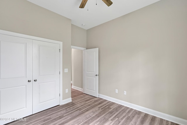 unfurnished bedroom with a closet, ceiling fan, and light wood-type flooring