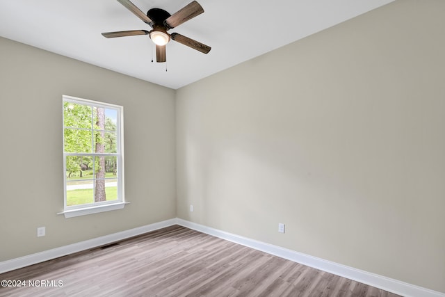 spare room featuring light wood-type flooring and ceiling fan