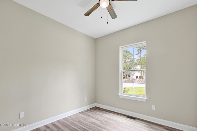 spare room featuring light hardwood / wood-style flooring and ceiling fan