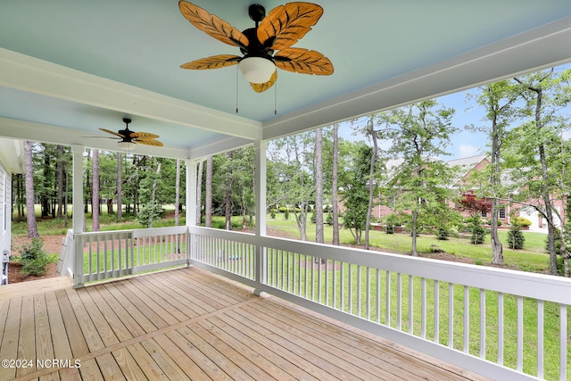 wooden deck featuring a yard and ceiling fan