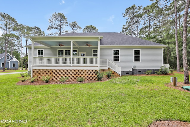 back of house featuring a yard and ceiling fan