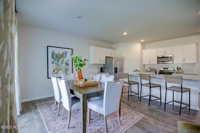 dining room with dark hardwood / wood-style flooring