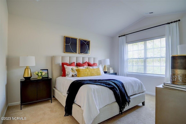 carpeted bedroom featuring vaulted ceiling