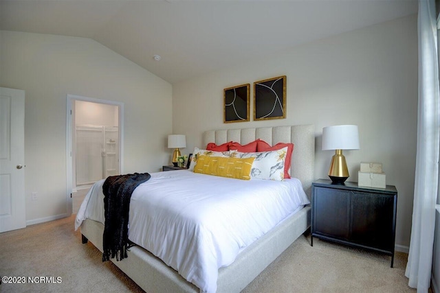 bedroom featuring vaulted ceiling, light carpet, a walk in closet, and a closet