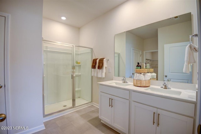 bathroom featuring vanity and a shower with shower door