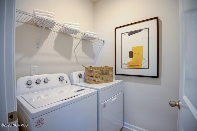 clothes washing area with independent washer and dryer