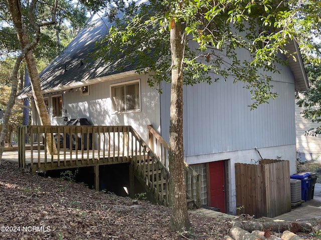 rear view of property with central AC and a deck