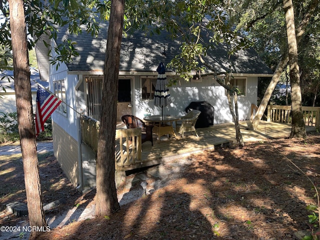 rear view of property with a wooden deck