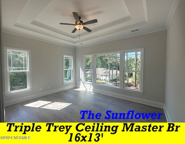 empty room featuring ceiling fan, crown molding, a wealth of natural light, and dark hardwood / wood-style flooring