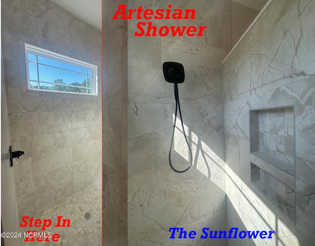 bathroom with a tile shower