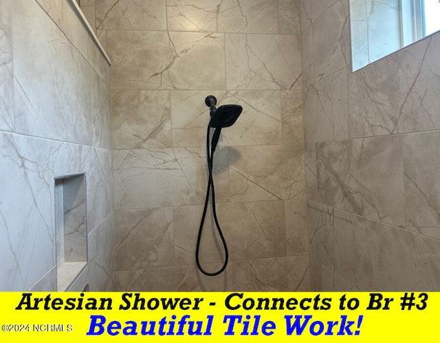 bathroom with tiled shower