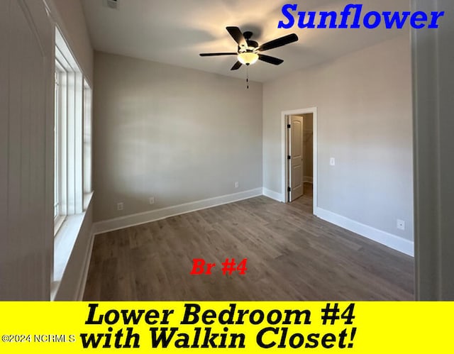 unfurnished room featuring dark wood-type flooring, ceiling fan, and a healthy amount of sunlight