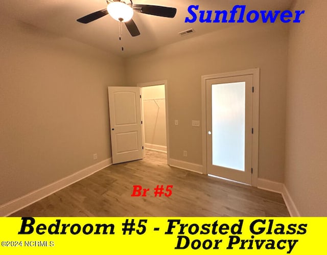 unfurnished room featuring hardwood / wood-style floors and ceiling fan