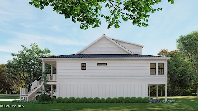 1550 Windsong Dr SW, Ocean Isle Beach, NC 28469 - view of property exterior with a lawn, stairway, and metal roof