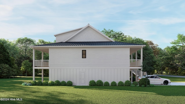 view of side of home featuring a balcony and a lawn