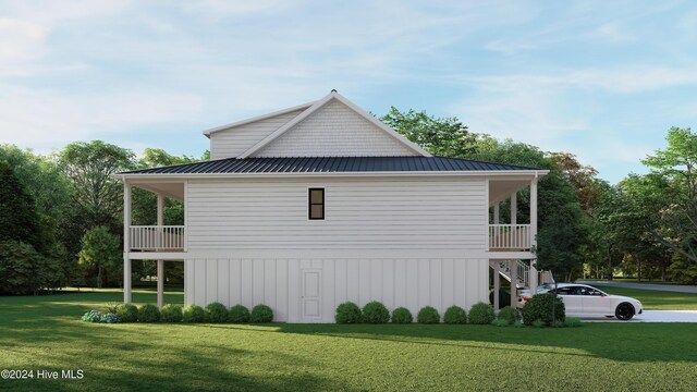 1550 Windsong Dr SW, Ocean Isle Beach, NC 28469 - view of home's exterior with a yard, stairs, a standing seam roof, and metal roof