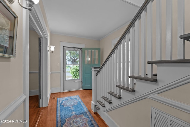 entrance foyer with wood-type flooring and ornamental molding