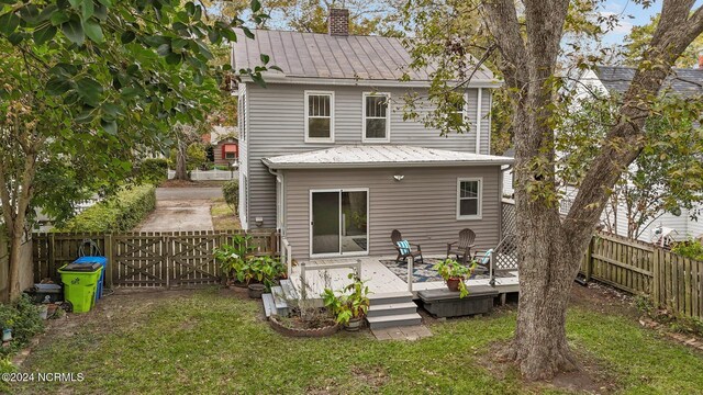 403 Ave D, New Bern, NC 28560 - rear view of property with a wooden deck, a chimney, metal roof, and a gate