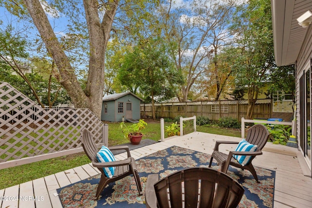 view of patio / terrace featuring a fire pit, a wooden deck, and a shed