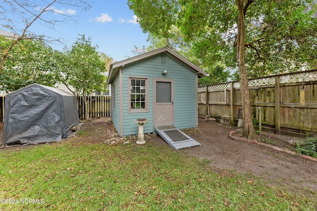 view of outbuilding featuring a lawn