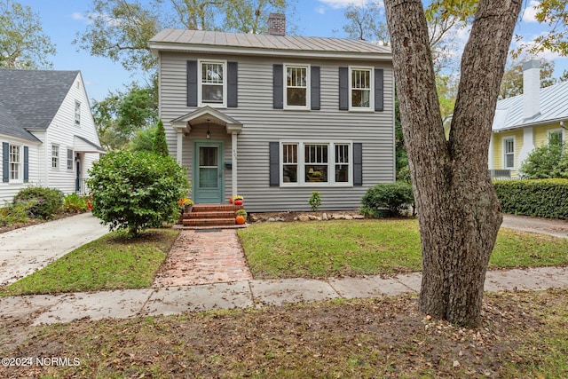403 Ave D, New Bern, NC 28560 - view of front of home featuring a chimney, metal roof, and a front lawn