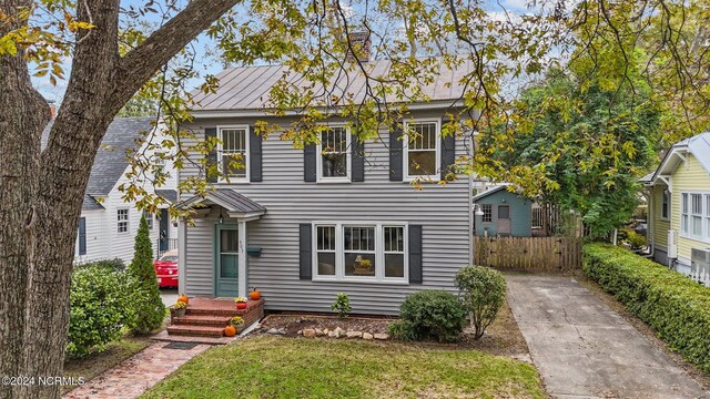 403 Ave D, New Bern, NC 28560 - view of front of property featuring concrete driveway, fence, and a standing seam roof