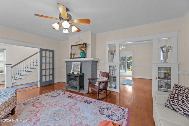 403 Ave D, New Bern, NC 28560 - living room with wood finished floors, stairs, a ceiling fan, baseboards, and a wood stove