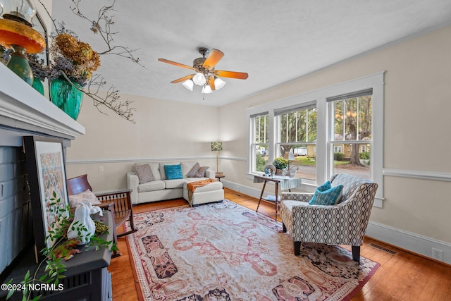 living room with ceiling fan and light wood-type flooring