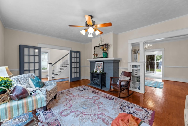 living room with ceiling fan with notable chandelier, french doors, hardwood / wood-style floors, and plenty of natural light