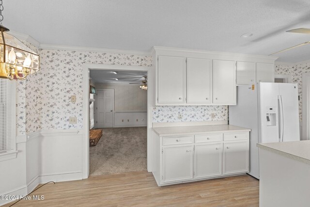 unfurnished dining area featuring a chandelier, hardwood / wood-style floors, a textured ceiling, and ornamental molding