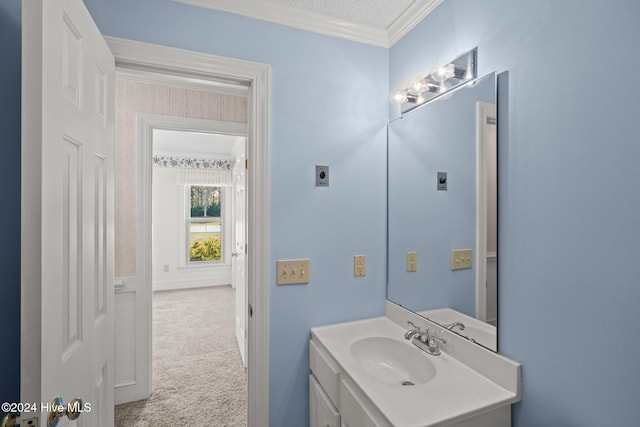 bathroom with a textured ceiling, vanity, and crown molding