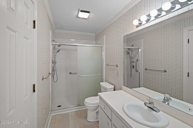 unfurnished bedroom with crown molding, ceiling fan, a spacious closet, a textured ceiling, and light colored carpet