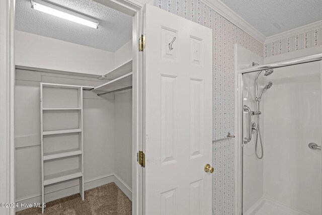 bathroom with vanity, a textured ceiling, crown molding, and tile patterned flooring