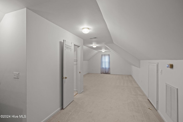 bonus room featuring light carpet and lofted ceiling