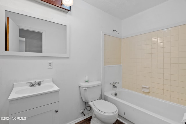 full bathroom featuring toilet, tiled shower / bath, a textured ceiling, and vanity