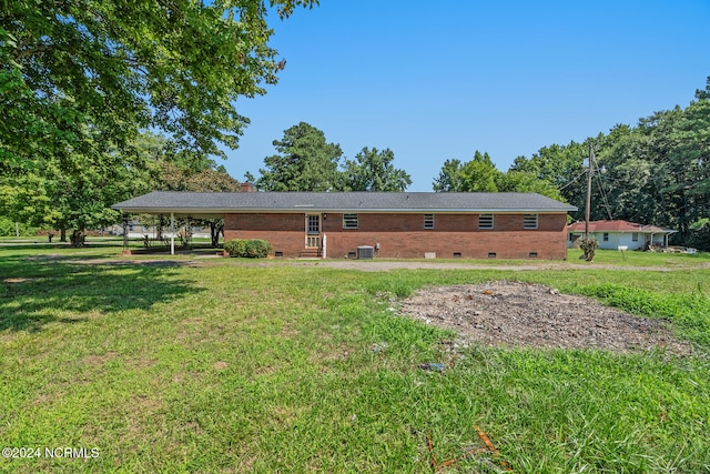 rear view of property with a yard