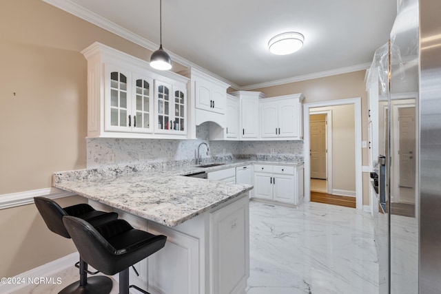 kitchen with light stone countertops, hanging light fixtures, white cabinets, and kitchen peninsula