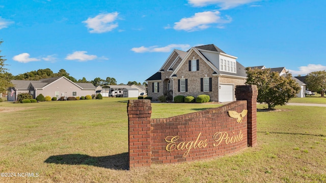 community / neighborhood sign featuring a lawn