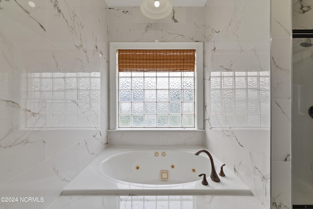 bathroom featuring a relaxing tiled tub