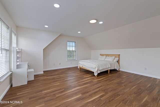 bedroom featuring lofted ceiling and dark hardwood / wood-style floors