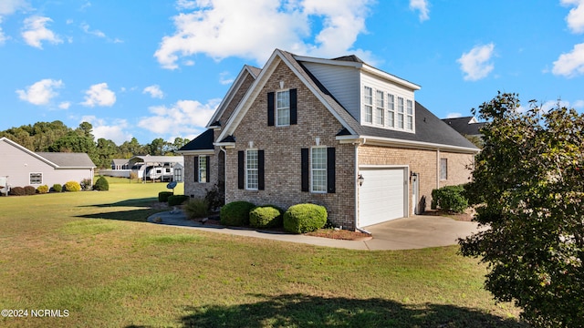 view of front property featuring a garage and a front lawn