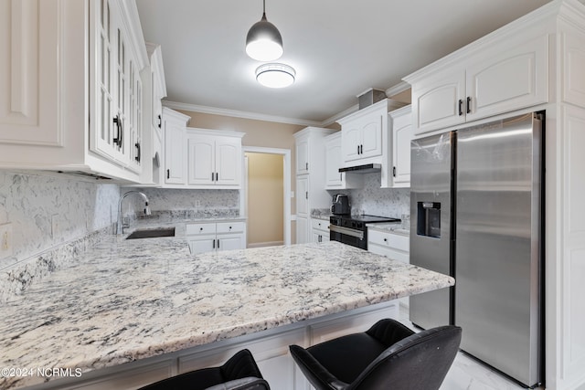 kitchen featuring stainless steel appliances, sink, decorative light fixtures, and white cabinets