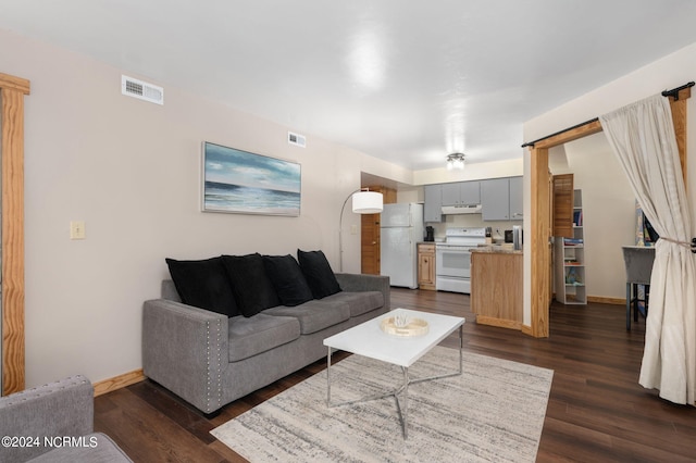 living room with dark hardwood / wood-style flooring