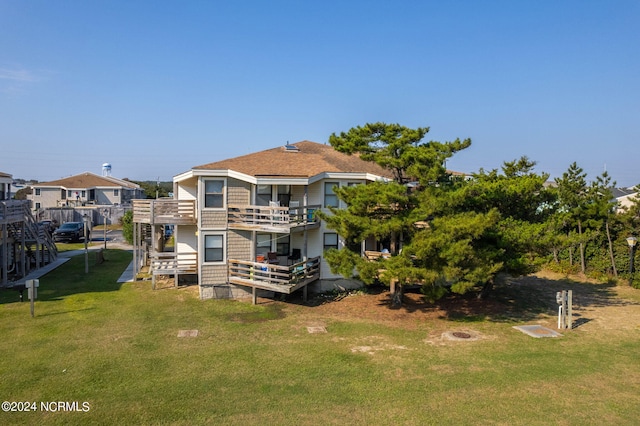 back of property featuring a lawn