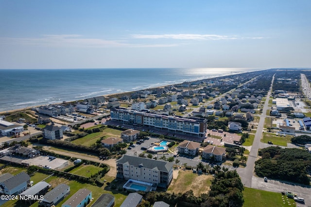 birds eye view of property featuring a water view and a beach view